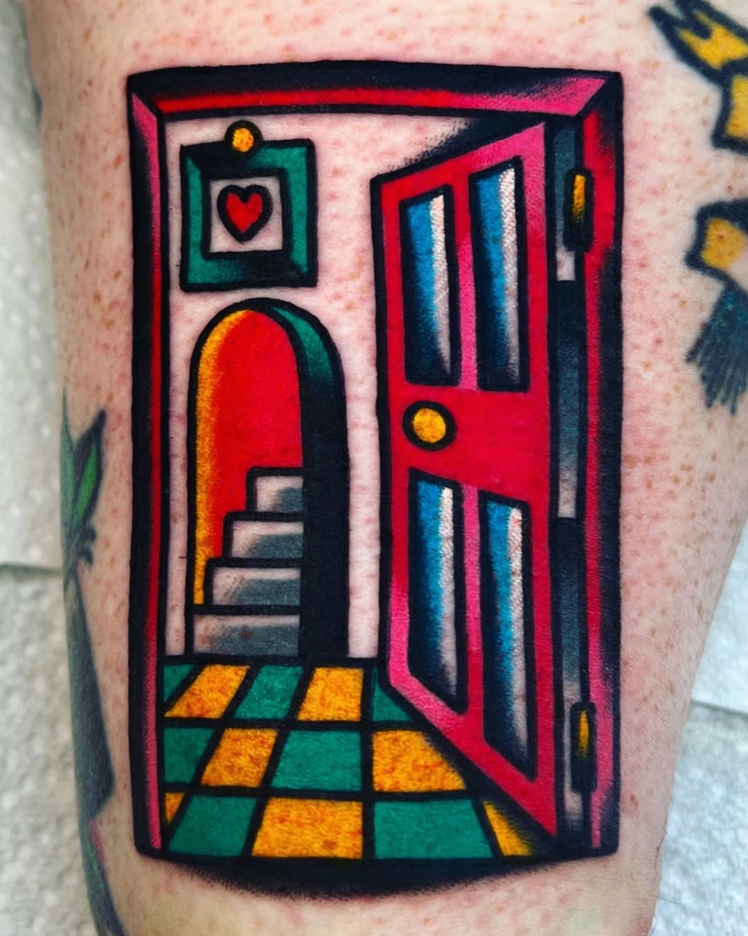 Interior room scene with arched doorway, heart portrait, red door, checkered floor in orange and green on leg.