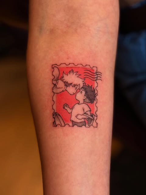 Rugrats characters Tommy and Dil in red tones with black outlines tattooed on the inner forearm.
