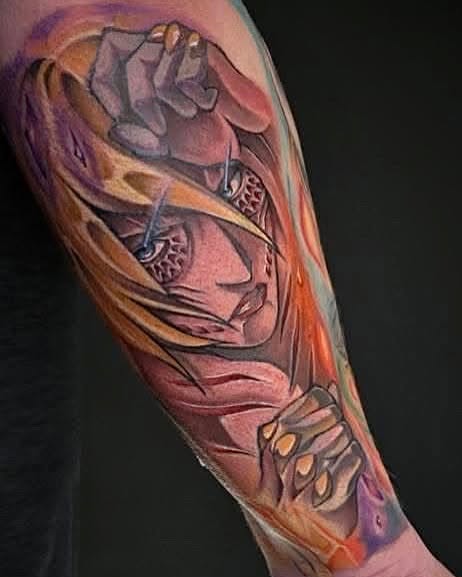 Two fierce lion heads with open mouths and detailed manes in warm orange, gold, and red tones on a forearm.