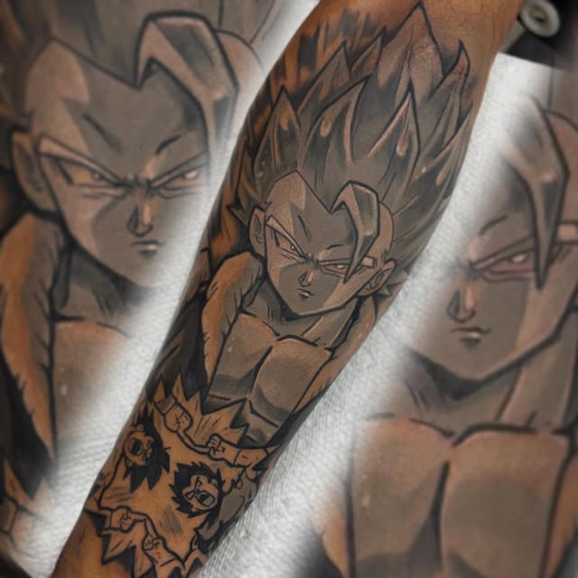 Dragon Ball Z character Vegeta with spiky hair and determined expression tattooed on forearm in black and grey ink, surrounded by energy effect details.