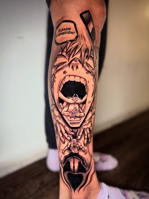 Manga character tattoo on forearm featuring an expressive face with open mouth, speech bubble, and anatomical details in black ink.