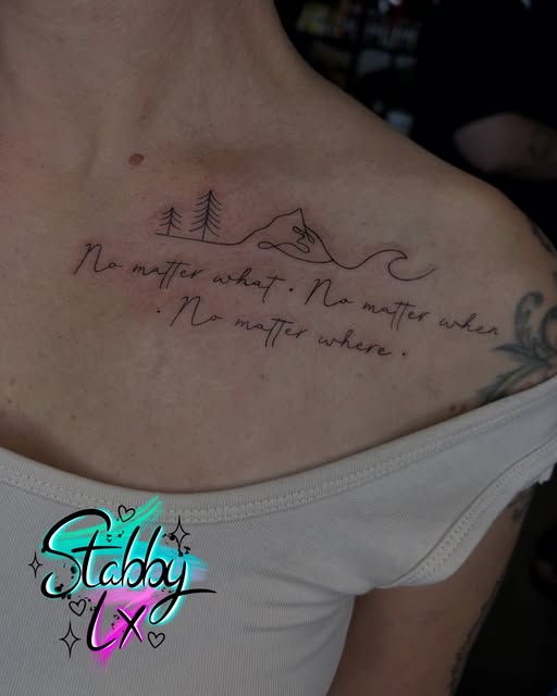 Chest tattoo featuring two pine trees and a mountain landscape with handwritten script reading 'No matter what. No matter when. No matter where.' with artist watermark.