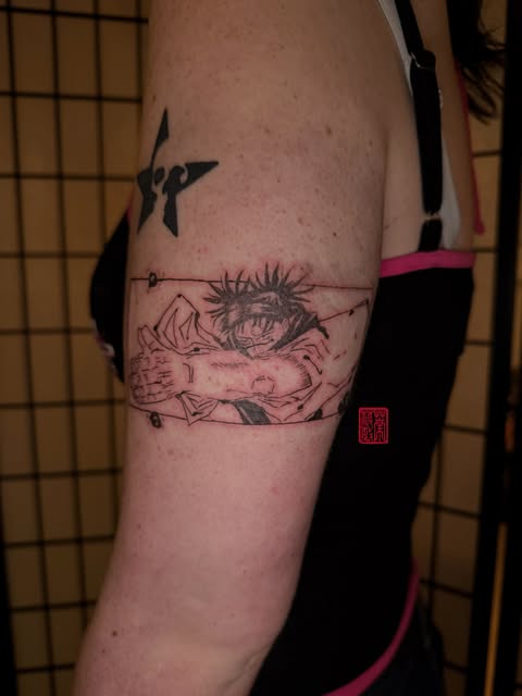 Jujutsu Kaisen character Yuji Itadori tattoo on upper arm featuring his spiky hair and facial features in black ink with fine line details.