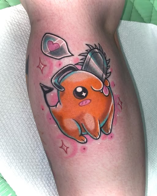 Orange Pokémon character Charmander with black outlines on a calf, surrounded by pink sparkles and a heart speech bubble.