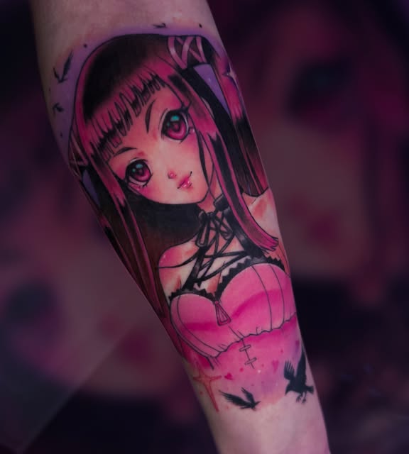 Anime girl character tattoo on forearm with long dark hair, large eyes, and pink outfit, rendered in vibrant magenta and black ink.