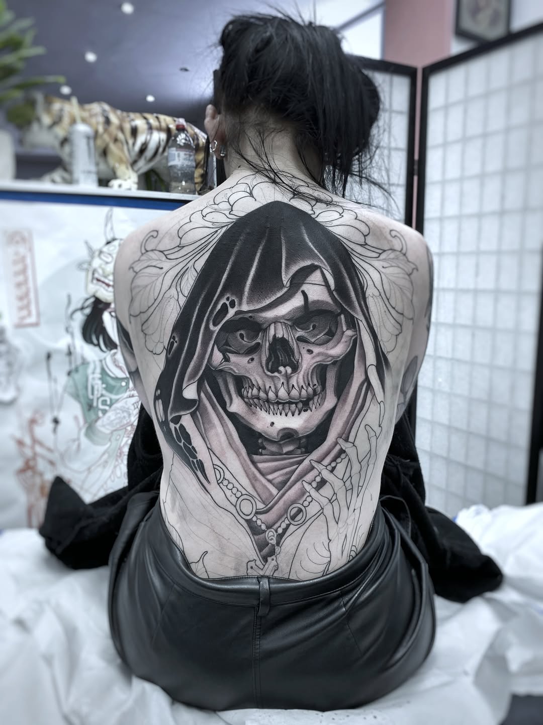 Large black and grey grim reaper skull with hooded robe and ornate details covering the entire back.