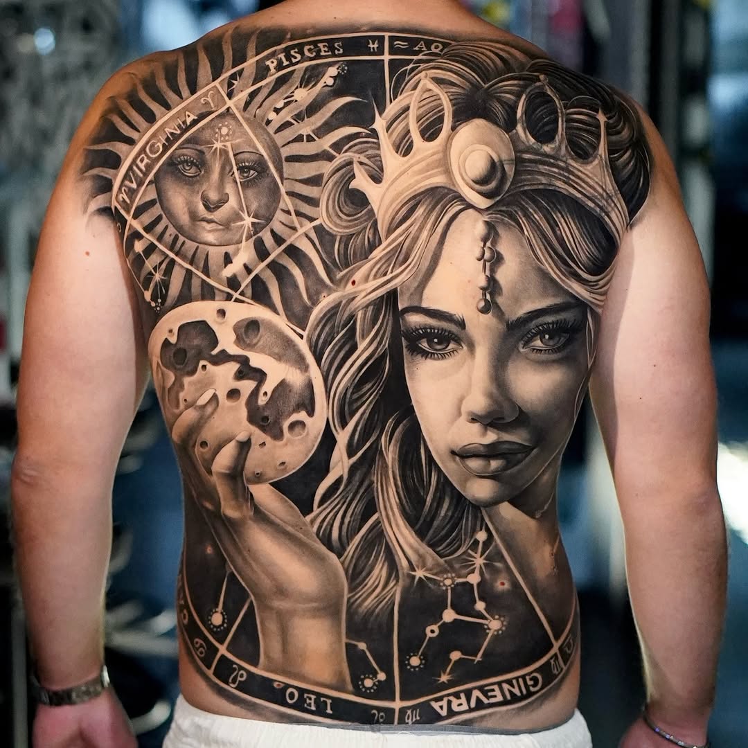 Back tattoo featuring a woman's portrait with flowing hair, sun face, moon, and zodiac elements in black and grey realism.