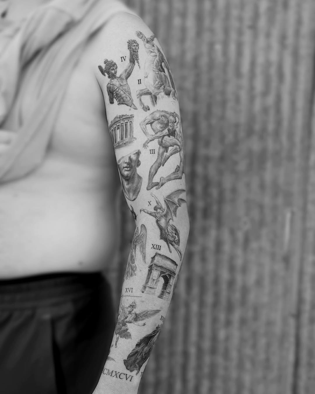 Full-sleeve classical engraving-style tattoo featuring cherubs, architectural elements, and mythological figures with Roman numerals.