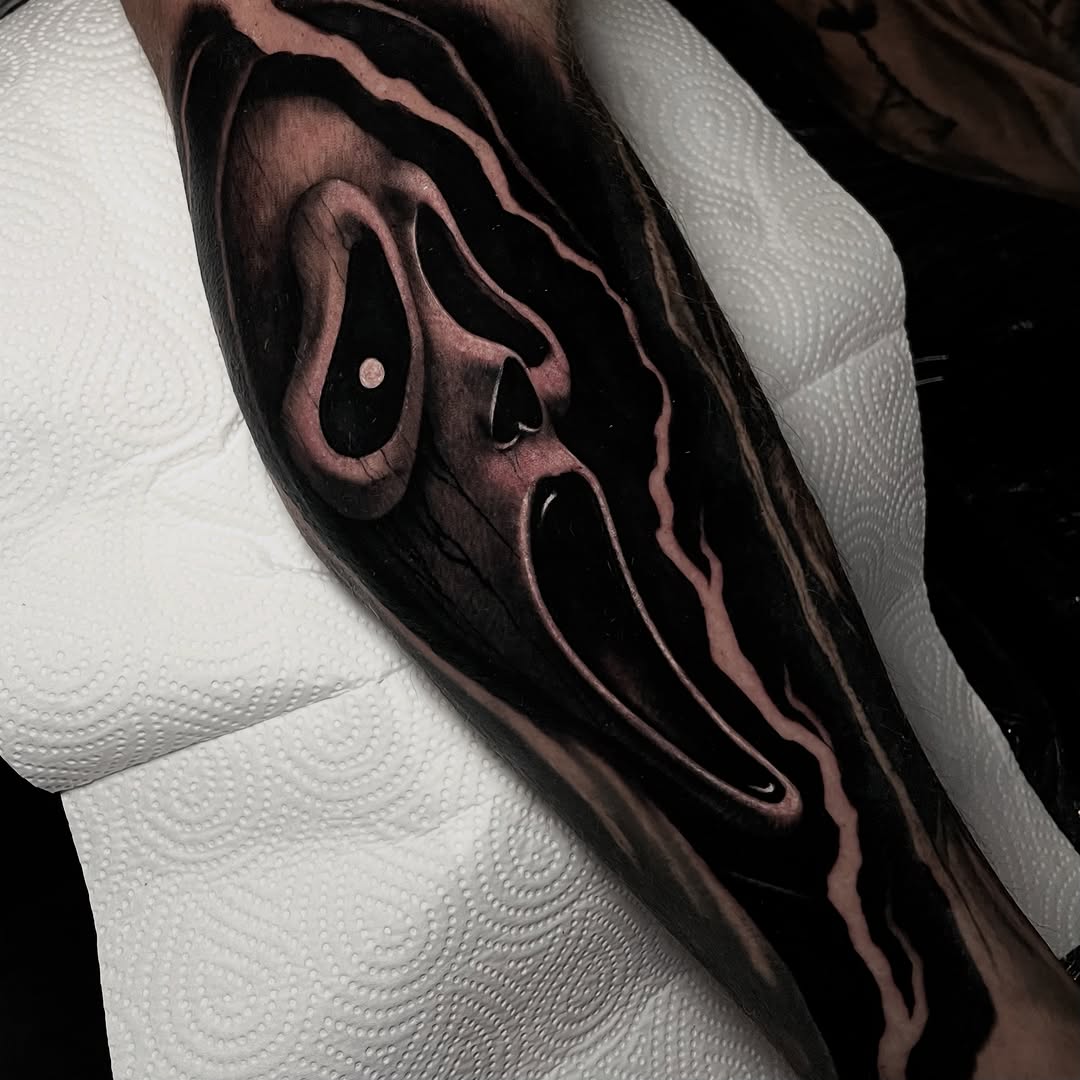 Monochromatic portrait of a screaming face with dramatic shadow and light contrast on the forearm.