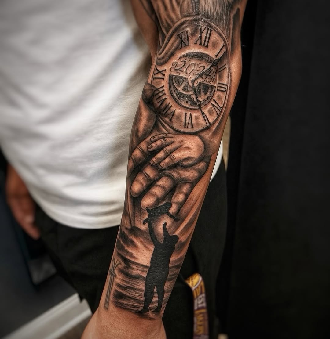 Black and grey full arm sleeve tattoo featuring a Roman numeral clock showing 2024, a detailed hand, and a silhouette figure below.