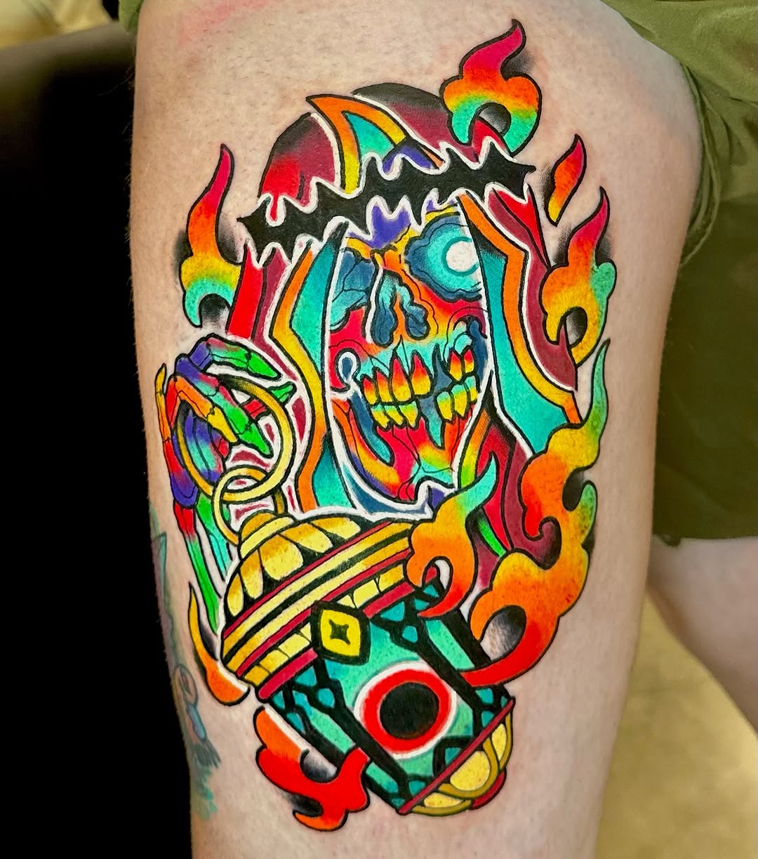 Colorful skull with rainbow flames and ornate geometric patterns on the thigh.
