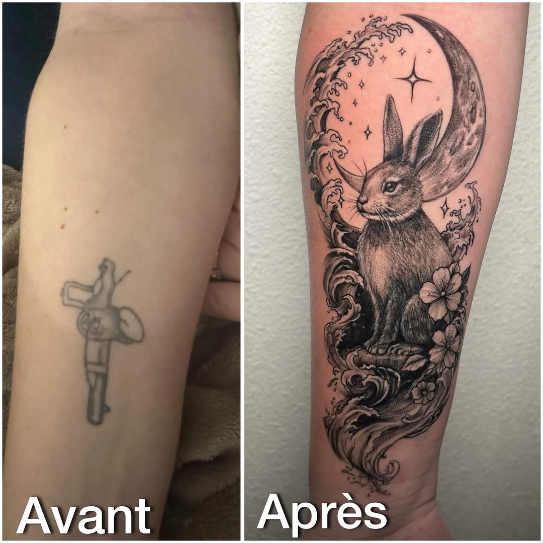 Celestial rabbit with moon, clouds, flowers, and stars covering older faded cross tattoo on leg.