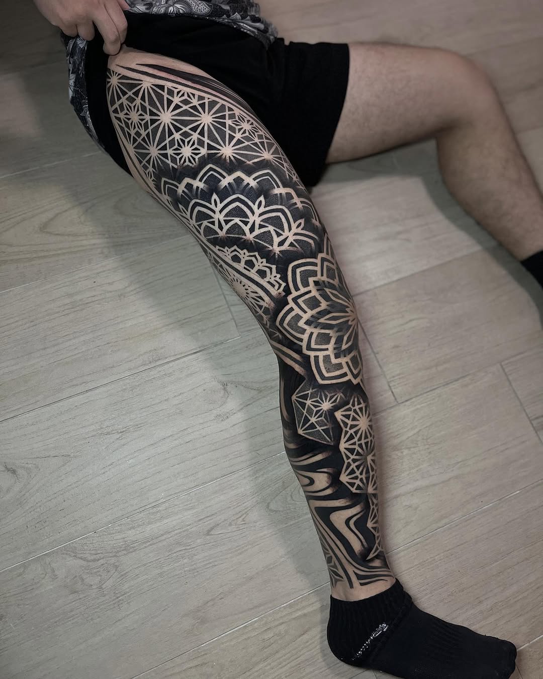 Full leg sleeve featuring geometric mandalas, sacred geometry patterns, and ornamental symmetrical designs in black ink.