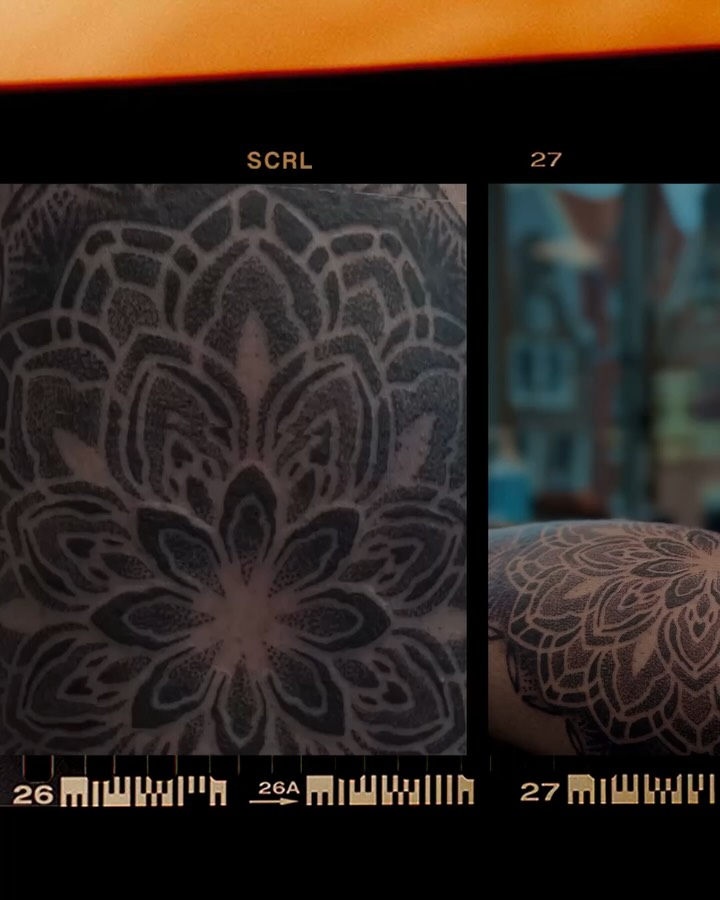 Symmetrical mandala-style tattoo with intricate geometric petal and leaf patterns in black ink on skin.