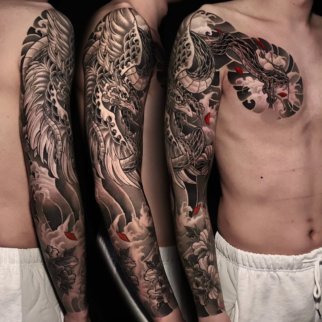 Full sleeve tattoo featuring dragons, waves, and ornamental details in black and grey with red accents on both arms.