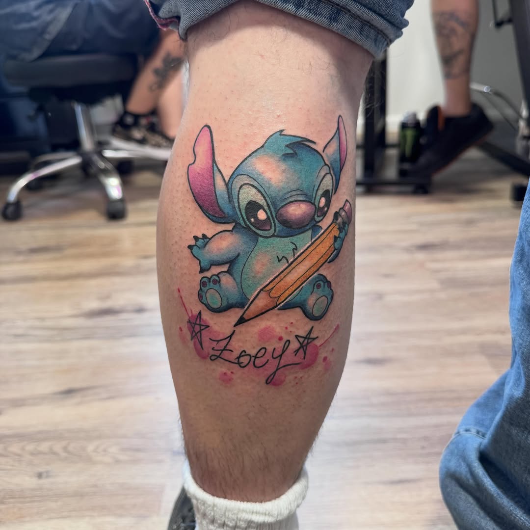 Stitch character holding pencil with 'Zoey' text and stars on calf, blue and pink coloring.