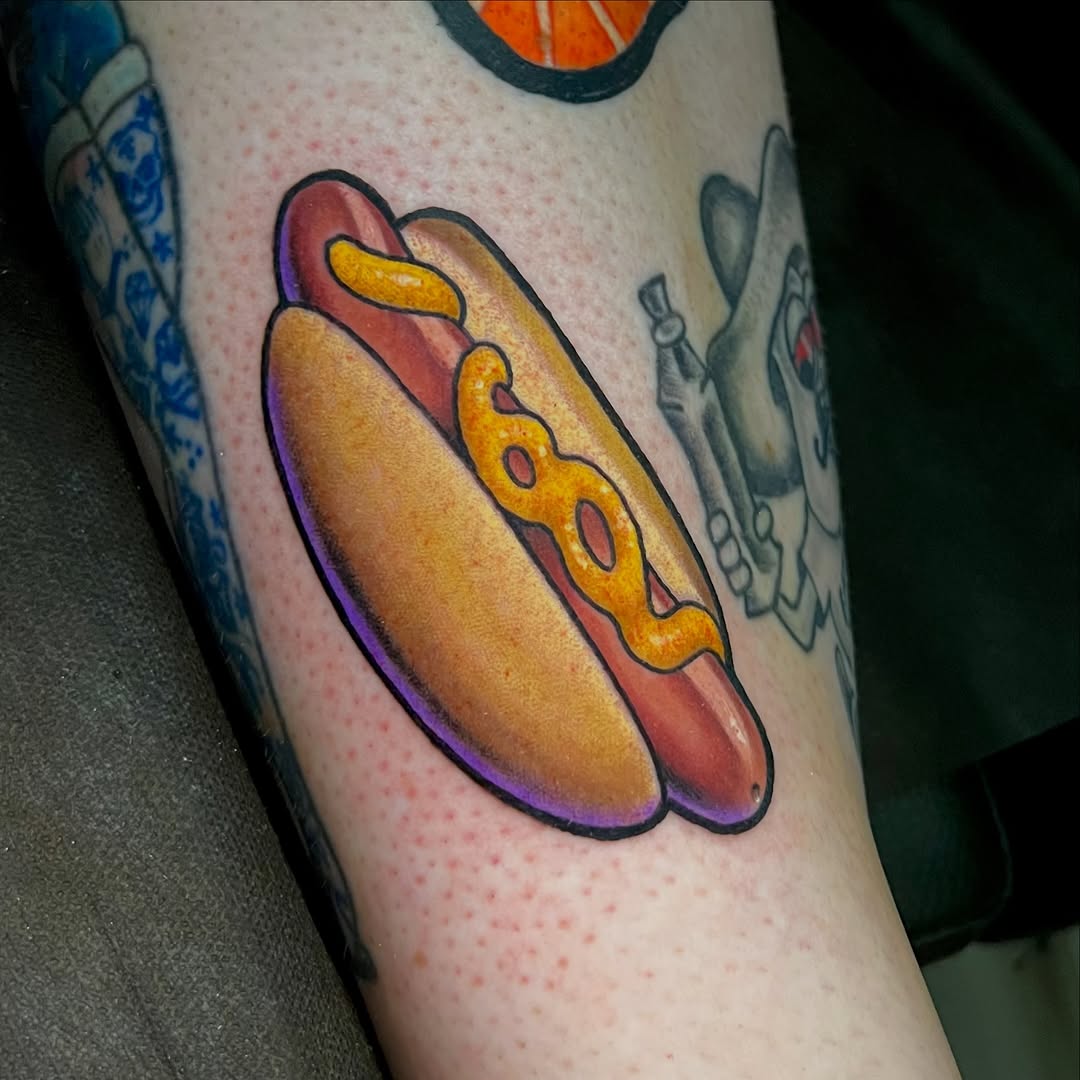 A colorful hot dog with mustard on the calf, featuring vibrant yellow, red, and purple tones with dimensional shading.
