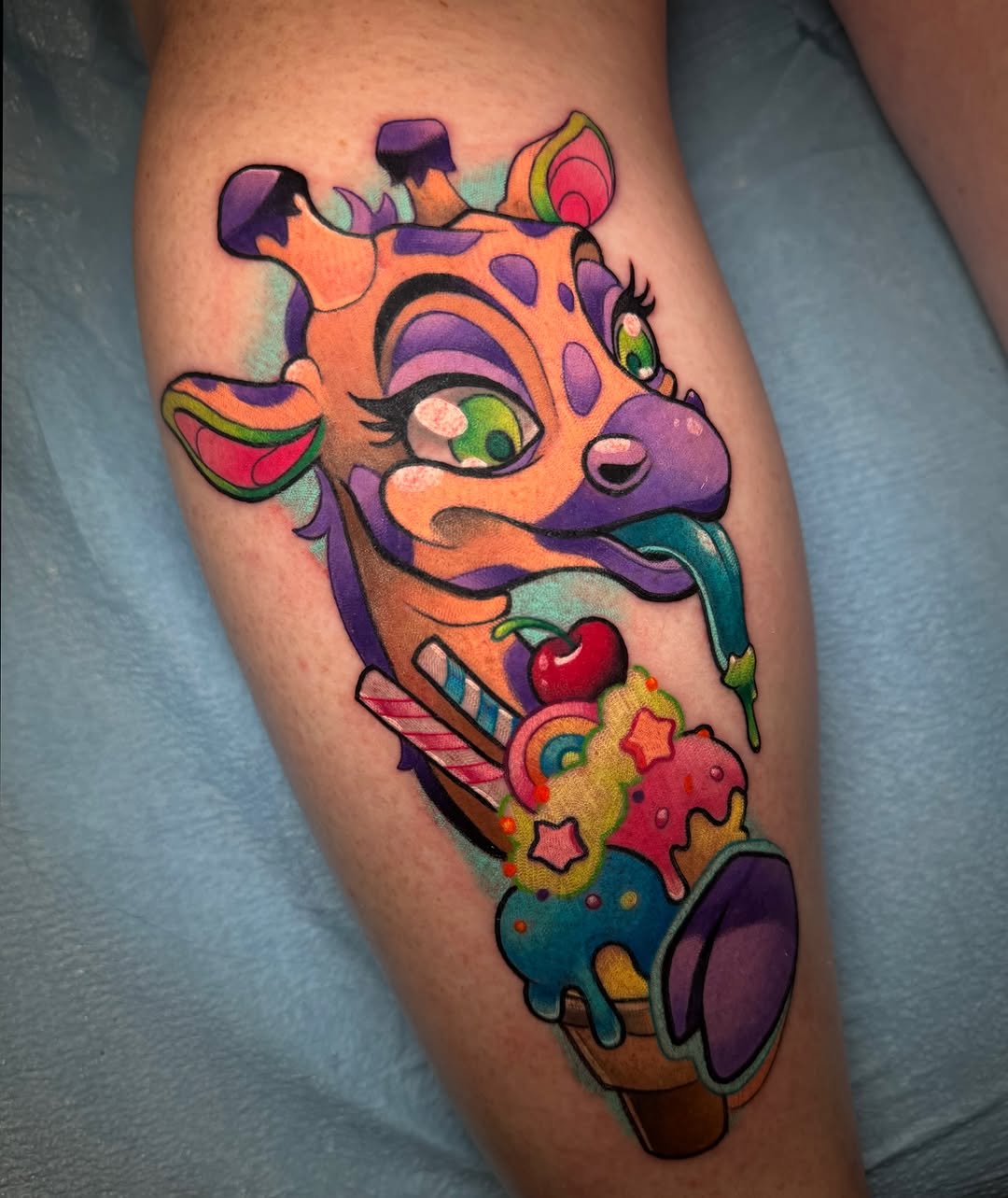 Colorful stylized giraffe head with exaggerated features, bright candy elements, and playful expressions on the calf.