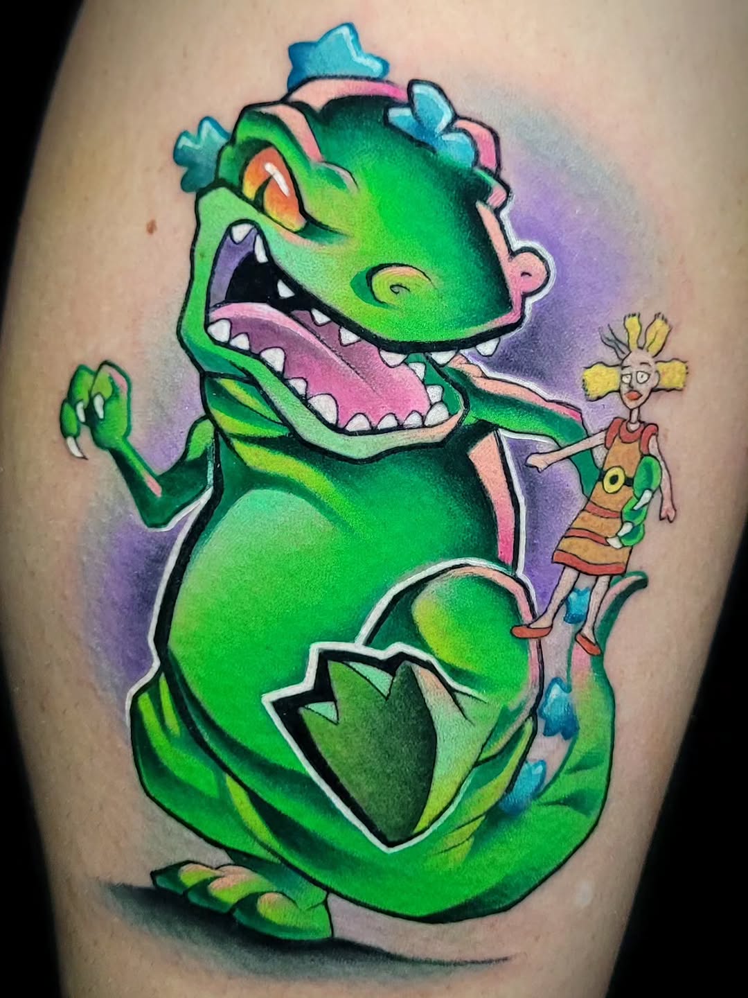 Bright green cartoon dinosaur with pink mouth holding a small blonde girl figure, on thigh with purple background.